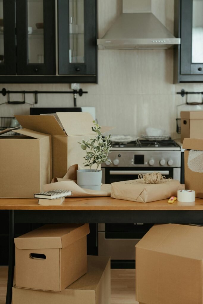 a table with boxes and a plant on it being decluttered using our spring cleaning hacks