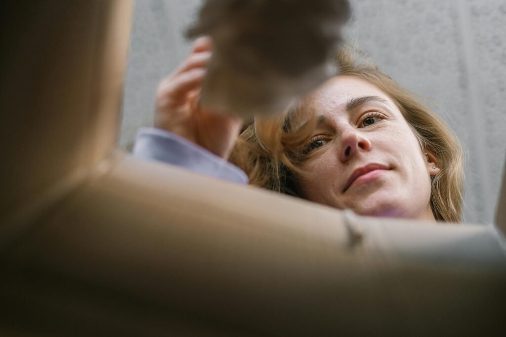 a woman decluttering and throwing out not needed things