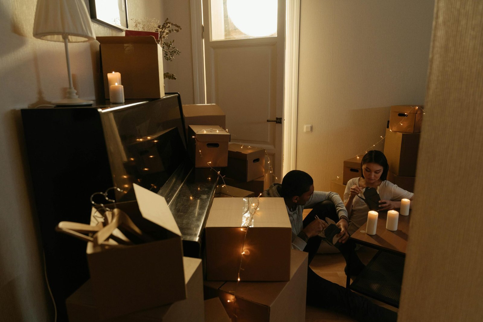 Couple sitting on the floor wondering how to organize shared closet